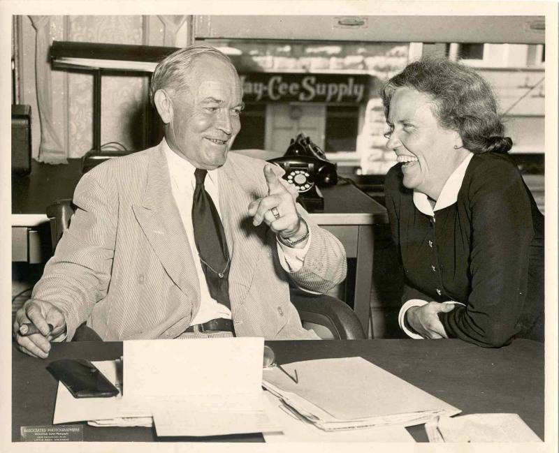 Campaign photo of Laney with a cigar laughing with a lady