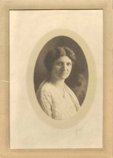 Photo of Mrs. Hayes wearing a white dress with a white shawl