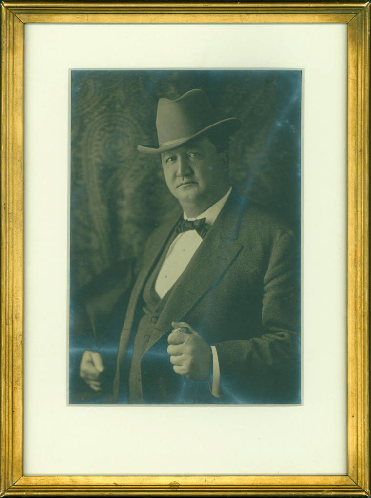 Framed photograph of Jeff Davis wearing suit and hat. 