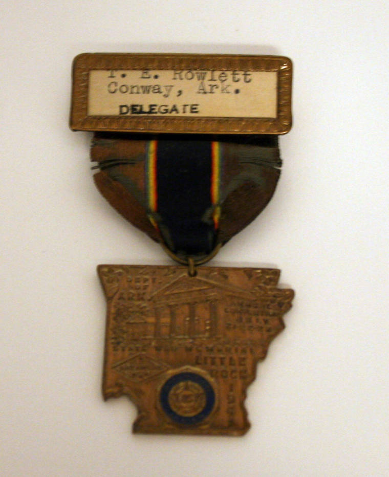 badge belonging to T.E. Rowlett; OSH engraving