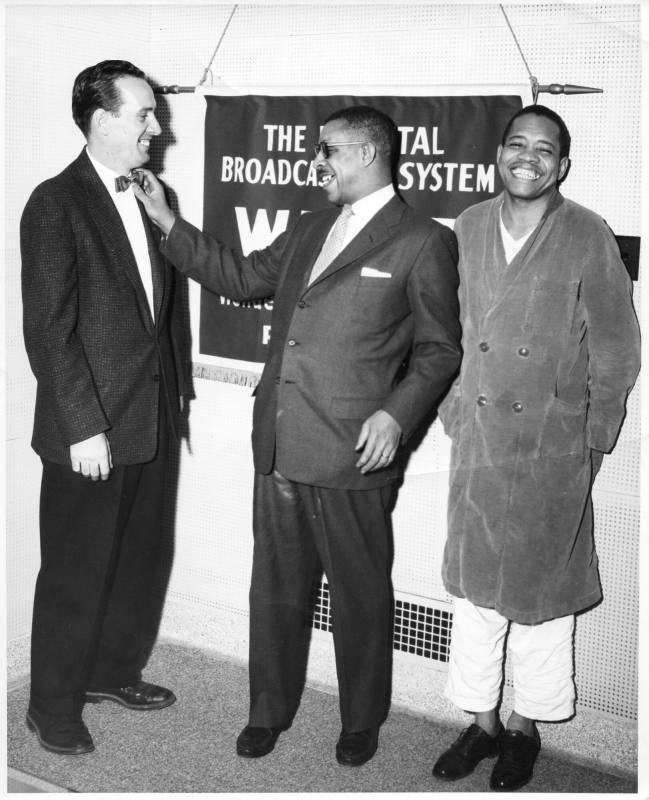 Black and white photograph of Al Hibbler standing between a  caucasian man wearing a dark suit  ...