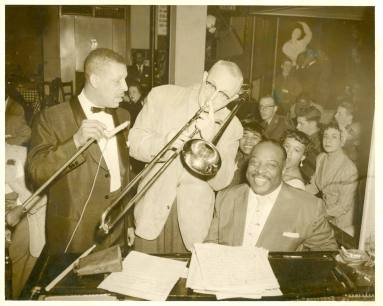 Black and white poto of Al Hibbler with Glen Miller who is playing trombone.