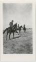 Photo of 3 men mounted on horses.