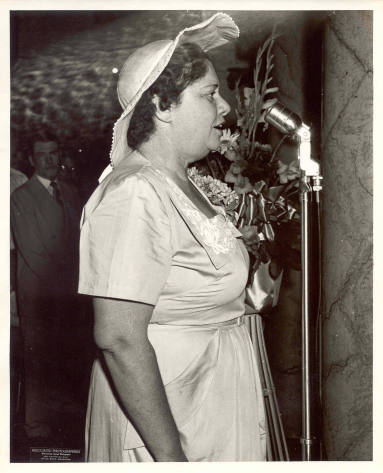 A Ben Laney campaign photograph with woman in hat at mic.