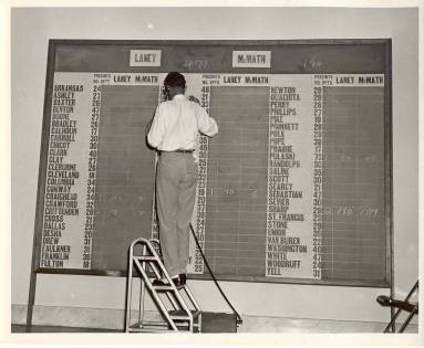 Photo of man reporting votes of counties for McMath or Laney