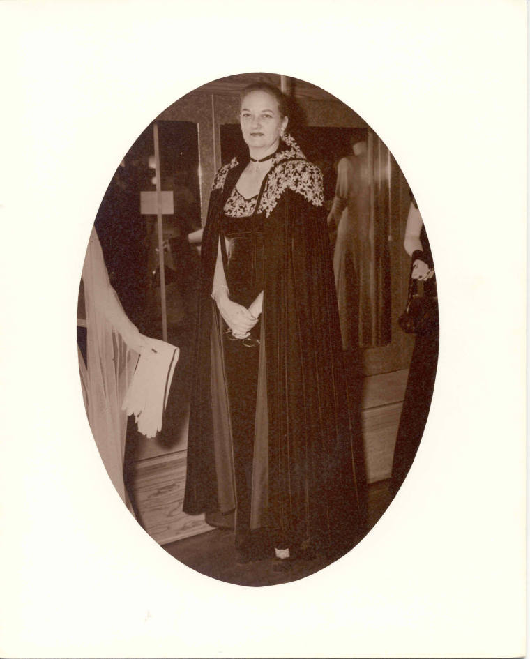 Photo of Mrs. McMath wearing a ball gown and cape 