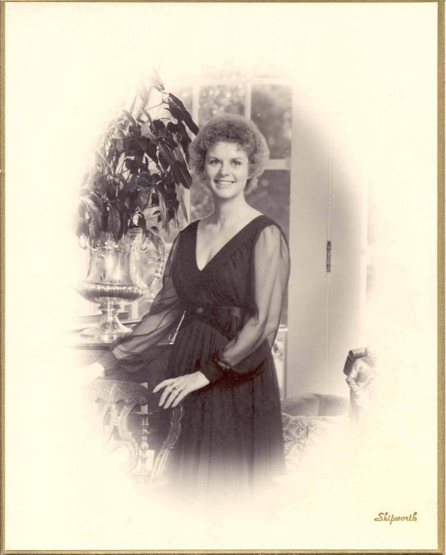 Photo of Mrs. David Pryor in a black dress looking at the camera.