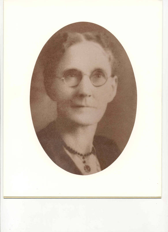 Photo of Mrs. G W Donoghey in a black dress facing the camera.