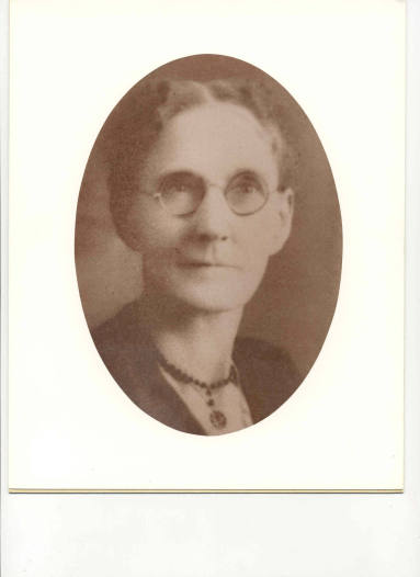 Photo of Mrs. G W Donoghey in a black dress facing the camera.