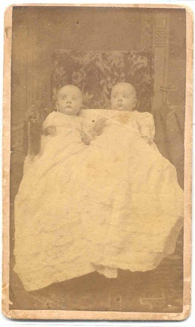 Gilbert and Lewis Davis as infants wearing long white gowns