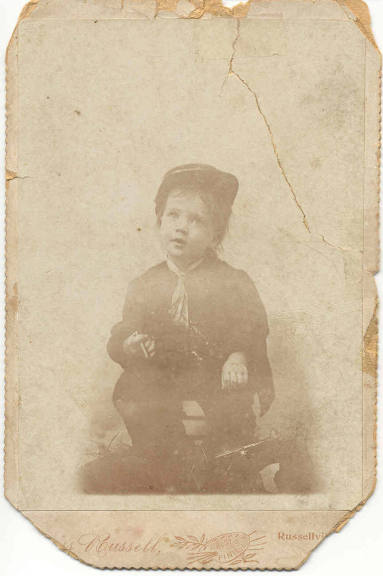 Seated young Janie Davis wearing military cap and uniform.