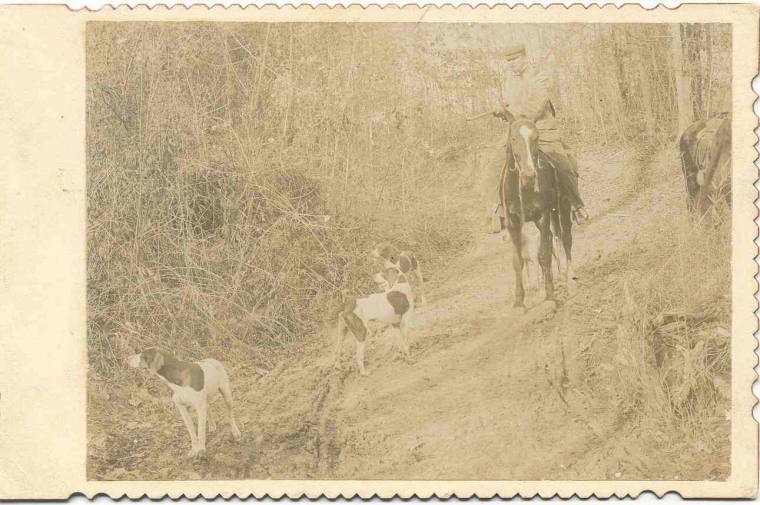 Jeff Davis on horseback wearing cap and holding a shotgun