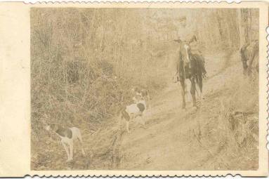 Jeff Davis on horseback wearing cap and holding a shotgun