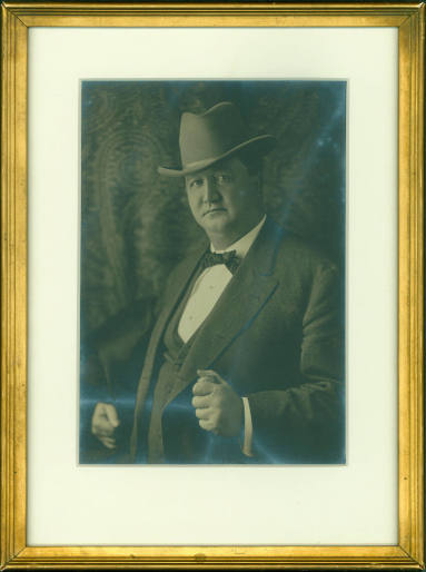 Framed photograph of Jeff Davis wearing suit and hat. 
