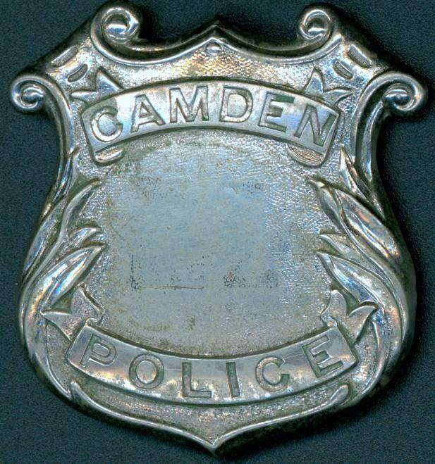 Silver badge from Camden Police Dept.