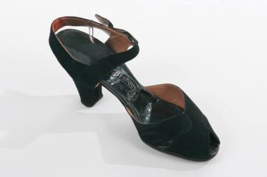 Mrs. Laney's black suede shoe with strap across ankle